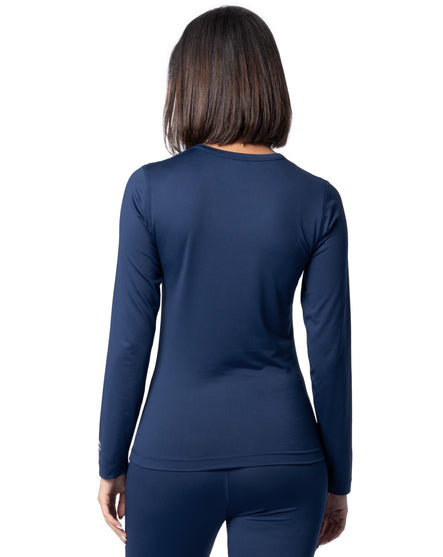 Person wearing a navy long-sleeve top and pants on a white background