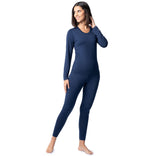 Woman wearing a navy blue long-sleeve top and leggings on a white background