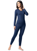 Woman wearing a navy blue long-sleeve top and leggings on a white background