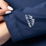 Close-up of a navy blue fabric with Coldpruf logo, held by a hand.