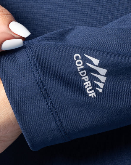 Close-up of a navy blue fabric with Coldpruf logo, held by a hand.