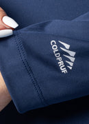 Close-up of a navy blue fabric with Coldpruf logo, held by a hand.