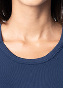 Close-up of a person wearing a navy blue shirt with a plain background